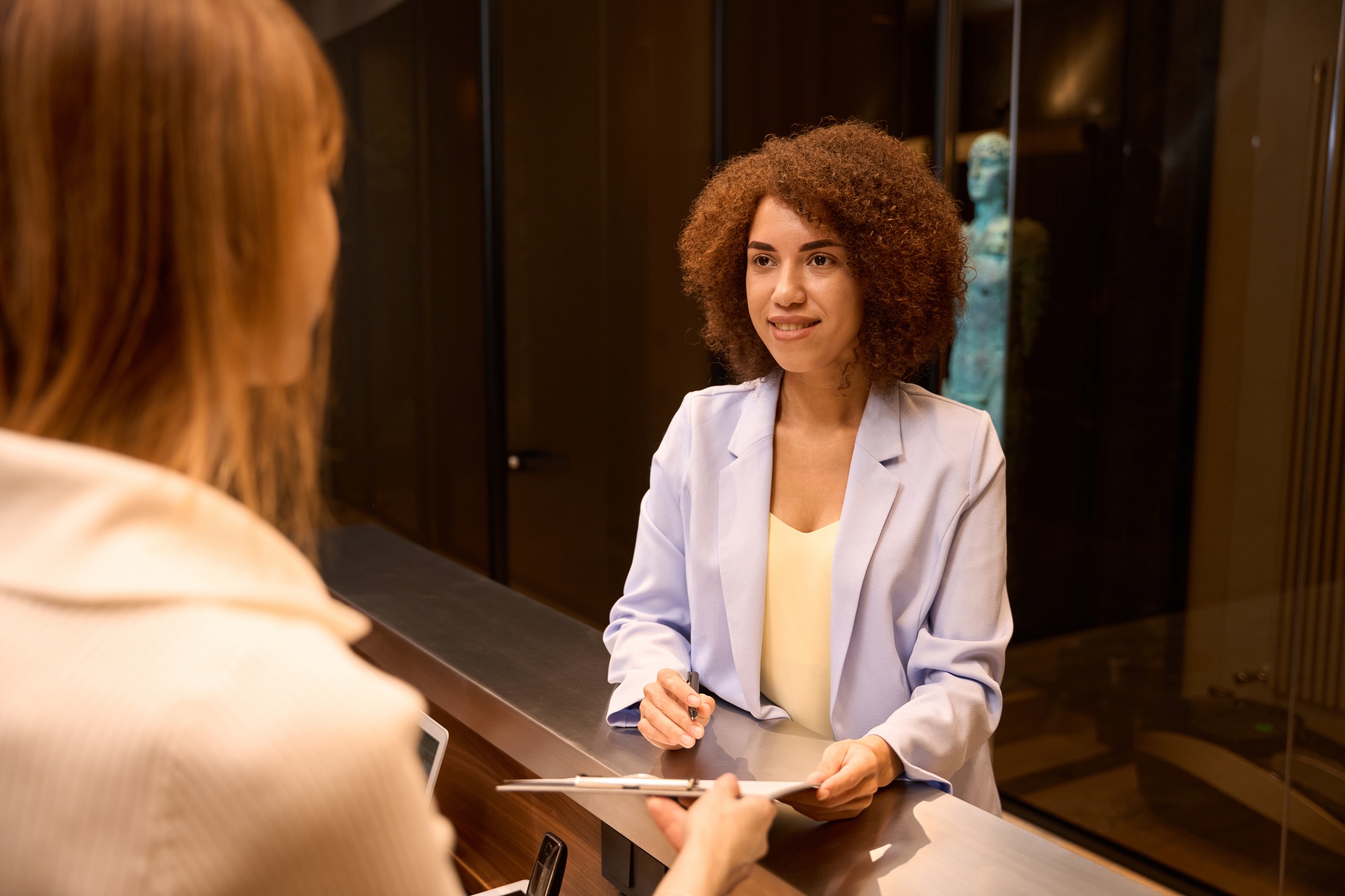 Elegant business woman filling form at counter